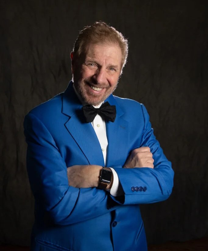 Mike with arms crossed and smiling. 